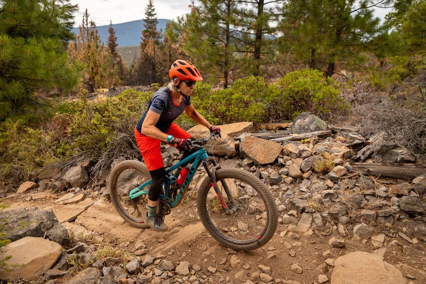 riding a mountain bike through a rock garden