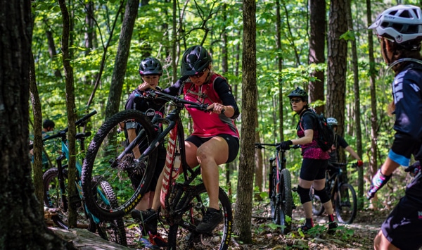 A mountain biker riding up a trail.