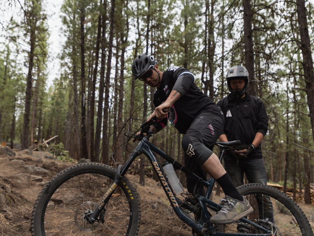 mountain biker dismounting off of a bike