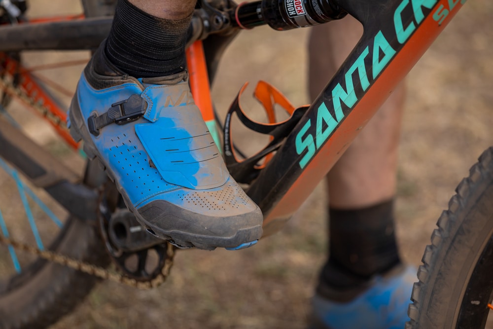 Blue clipless mountain bike shoes clipped into a pedal