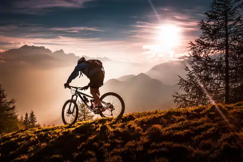 Beautiful sunset scene of mountain biker on a trail