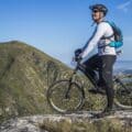 Man wearing a backpack sitting on a mountain bike